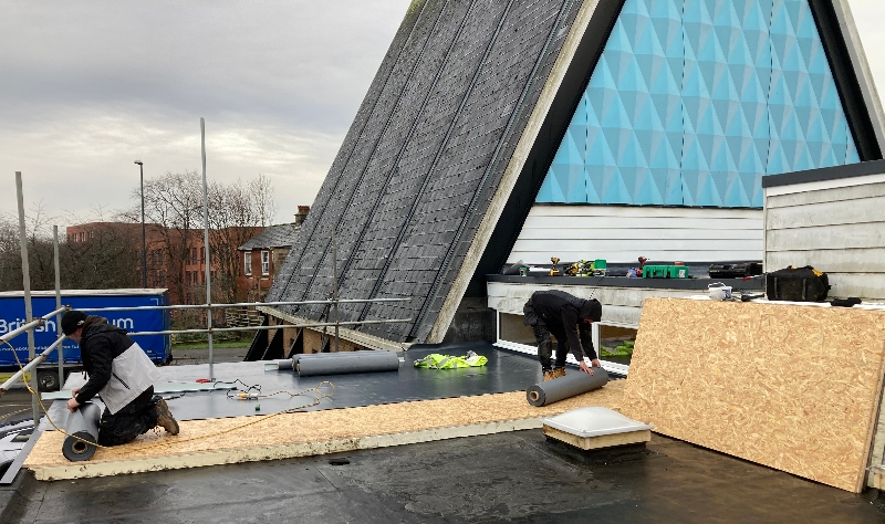 Derby Urban Church roof with 2 workmen installing insulation