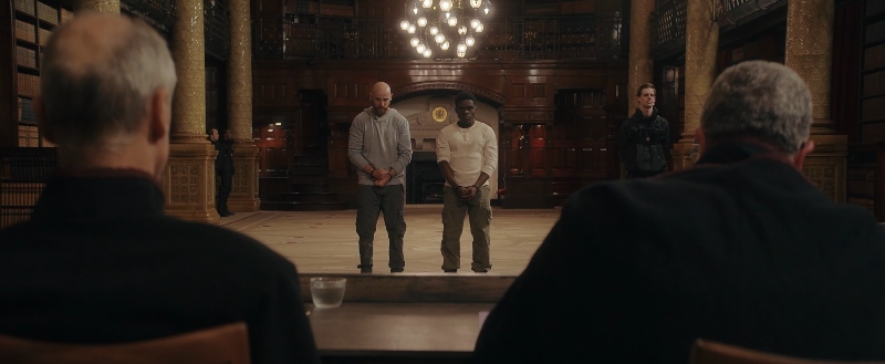 Scene from "Testament" featuring two apostles being questioned by the religious leaders