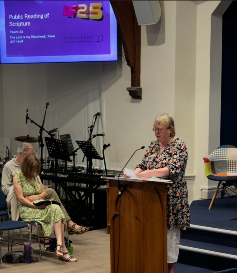 Public reading of scripture - a woman reads from a lecturn at a church