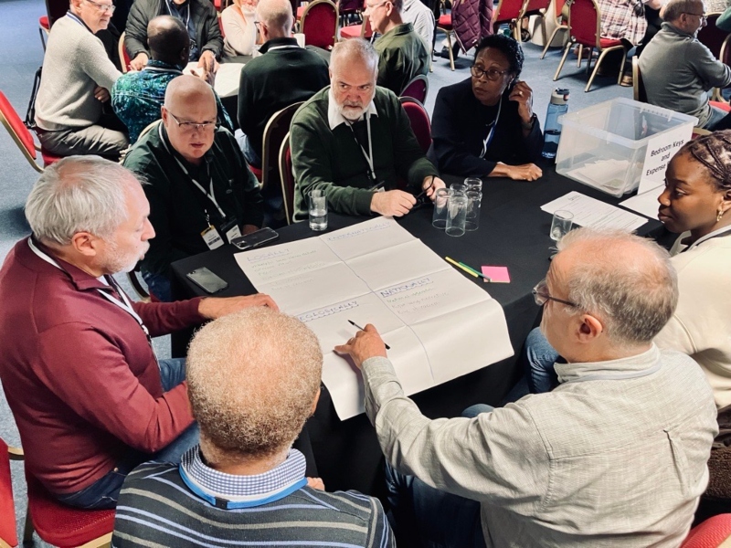 Members of Council sit around a table in discussion