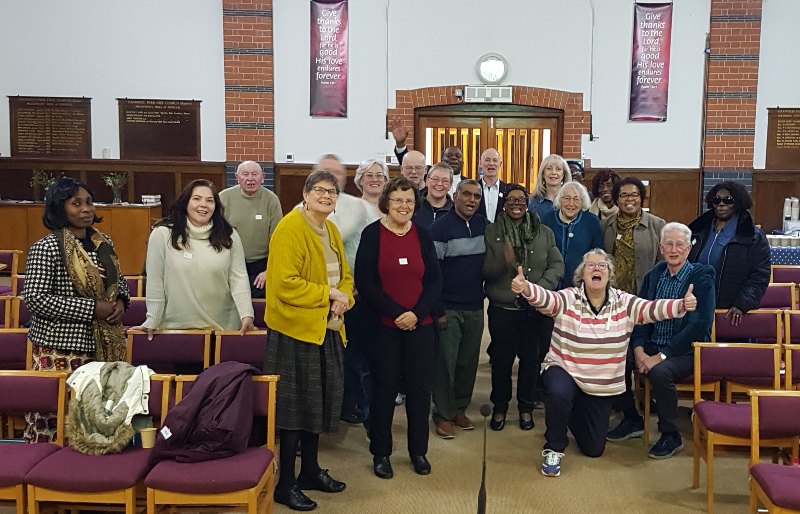 Hub at Oakwood Oct25 a group of around 20 people in a Baptist church gather for a photo