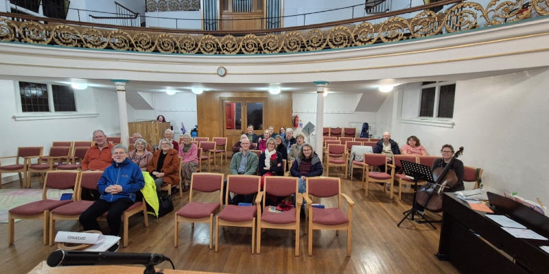 Around 25 people from the Bucks Hall Church hub sit around a church